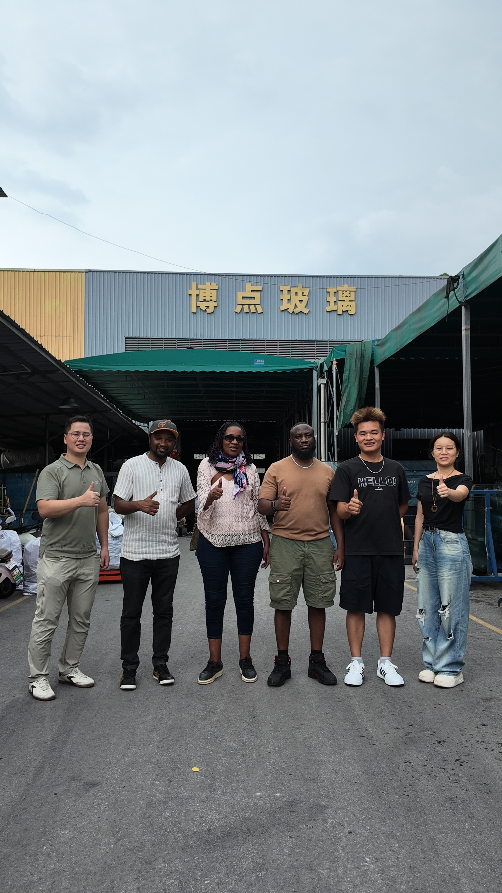 Group of overseas clients at BDGLASS factory exterior